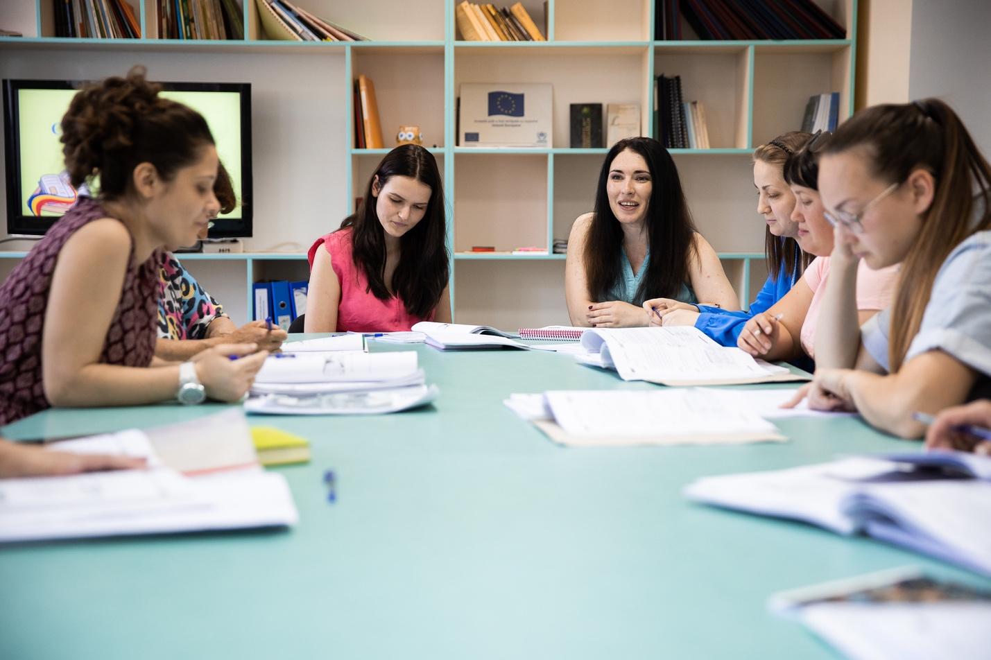 A group of women sitting around a table

Description automatically generated